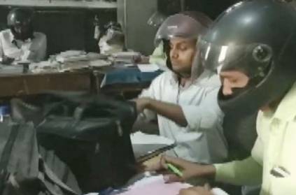 Govt staffs wear helmet for safety while working in office