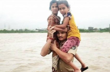 Gujarat police constable carried two children on his shoulders