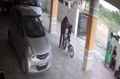 Man beating a 7 year old boy for cycling in a parking lot