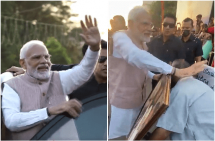 PM Modi gets down his car to accept portrait of his mother