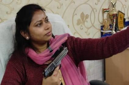 Trinamool Congress women\'s wing executive posing with a gun