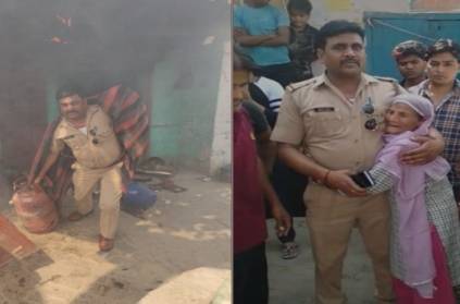 UP police officer walks into burning house retrieves lpg cylinders