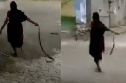 Woman dragging cobra by tail and throwing it goes viral