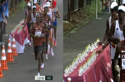 olympic france marathon runner controversy knock water bottles