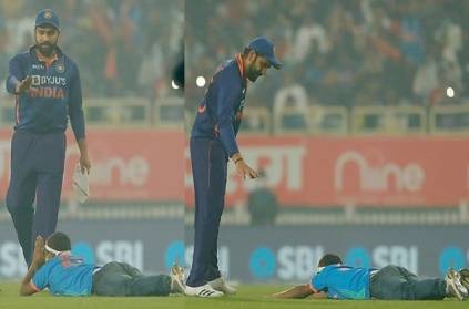 Photo of a fan falling at the feet of Rohit Sharma