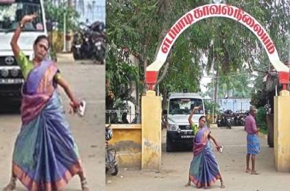 A woman dancing in front of Salem Edappadi police station