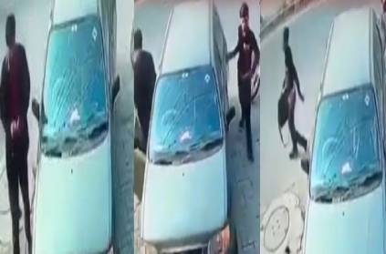 CCTV footage of a man stealing a laptop from a car