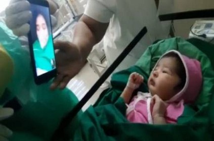corona positive mother talks with her newborn baby in video call