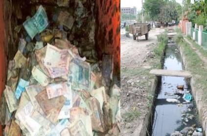 500 rupees notes floating in a sewer in Erode district