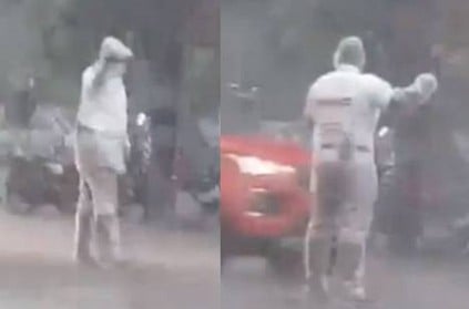 Police Constable Muthuraja regulating traffic in heavy rain video