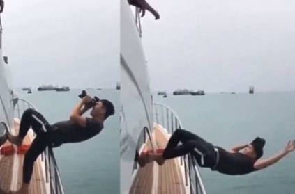 Video : Young Boy falling into sea while taking Photos