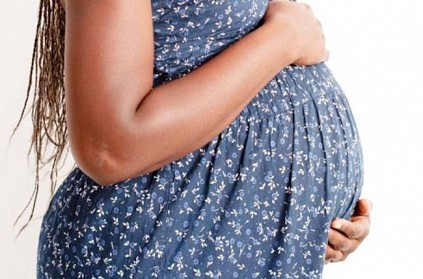 young girl pretended to pregnant with cloth on stomach