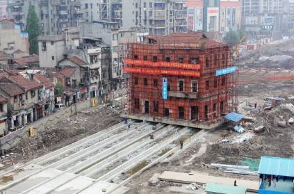 China 5 storey building shifted by mechanical legs