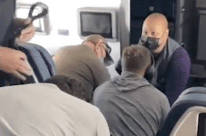 Delta flight attendants tackle potential hijackers and tie their wrist