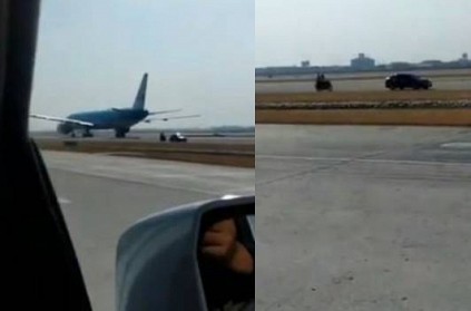 drunk man drives car on runway during flight landing video