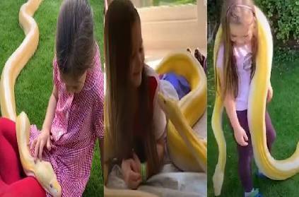 girl child has tea parties with 16 foot python snake viral