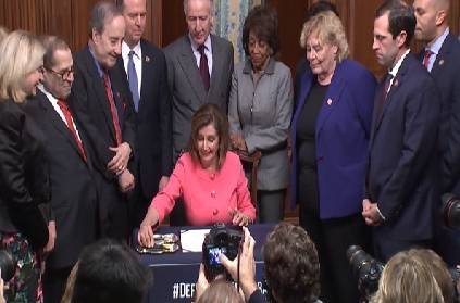 Nancy Pelosi uses multiple pens to sign the impeachment