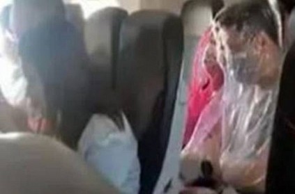 Passengers on board the plane, covered with plastic