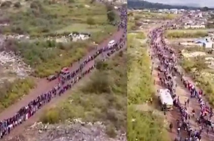 People queue for more than 2 miles to collect food in South Africa