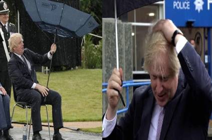 Prime Minister Boris Johnson struggle with an umbrella
