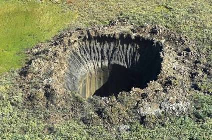 Russia huge crater 100 feet deep 70 feet diameter in Siberia