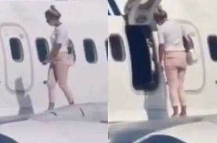 ukraine woman walks onto airplane wing complains about heat